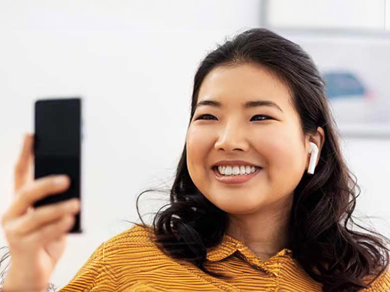 Close up of Asian young woman smiling taking a selfie