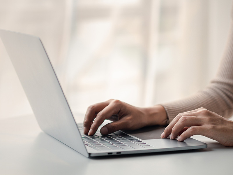 Up close female hands using laptop