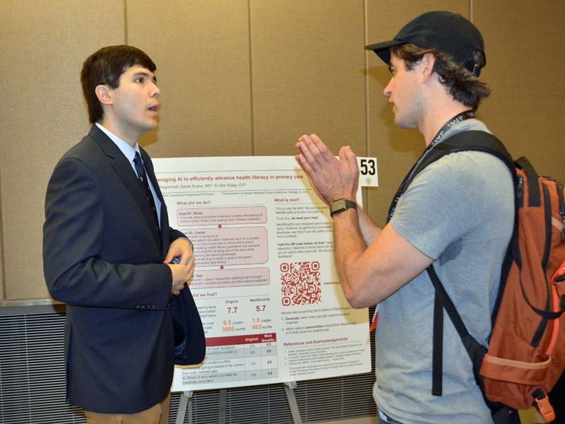 Fourth-year student Stephen Freeman presents his poster during an exhibit